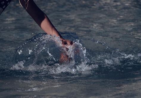 Premium Photo | Person splashing water