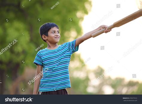 Rural Indian Child Playing Cricket Stock Photo (Edit Now) 670377412