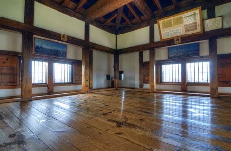 The castle's wood interior includes finely-worked floors, posts, beams, and shutters.