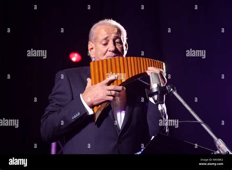 The famous Romanian musician Gheorghe Zamfir performing on the stage, playing the pan flute ...