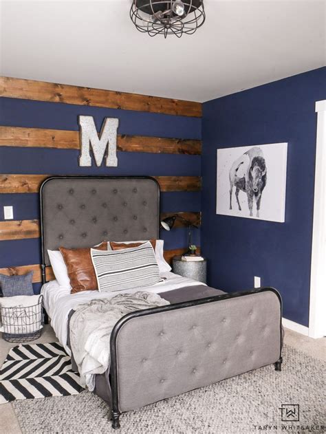 Rustic boy's room with dark navy walls and wood accents. Love the industrial decor and pops of ...