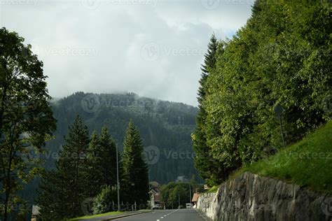 Majestic mountains in the Alps covered with trees and clouds 20498415 Stock Photo at Vecteezy