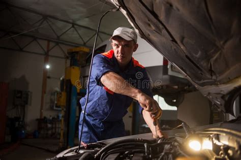 Car Mechanic Working In Auto Repair Service. Repairing Car Using Stock ...