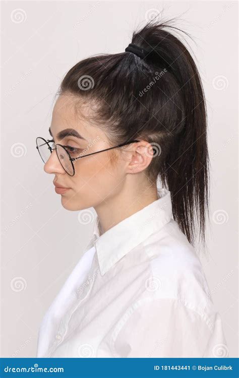 Beautiful Caucasian Hipster Girl with Black Hair and Glasses is Posing in Studio on Isolated ...