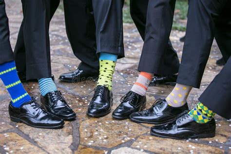 Group of Wedding Groomsmen Showing Their Socks at a Marriage Reception ...