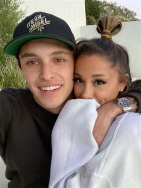 Ariana Grande gets a loving kiss from fiancé Dalton Gomez as she thanks ...