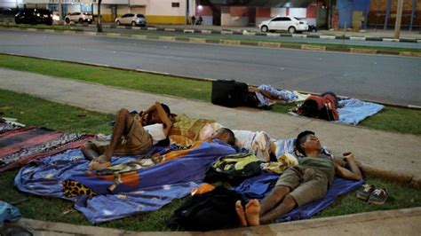 Venezuela migrants flee back across border with Brazil - BBC News