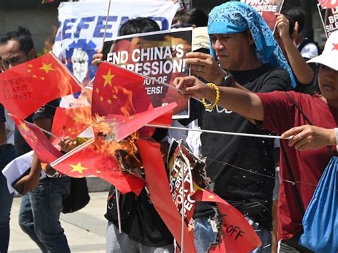 Protesters Burn Chinese Flags Following South China Sea Ship Sinking