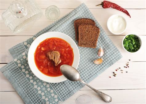 Premium Photo | Borsch with beef, sour cream and parsley with vodka ...