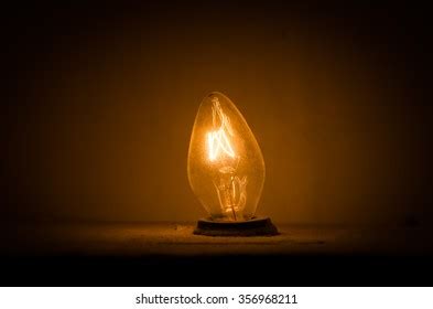 Exposed Yellow Filament Light Bulb Stock Photo 696074149 | Shutterstock