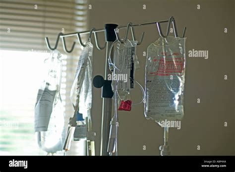 rack of IV intravenous bags hanging in hospital intensive care ward ...