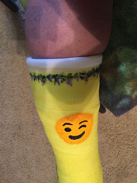 a person wearing yellow socks with a smiley face painted on the side of ...