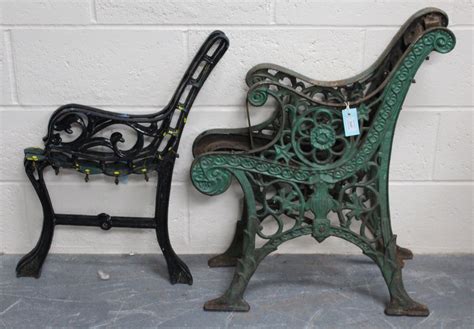 A pair of late Victorian green painted cast iron bench ends, decorated ...