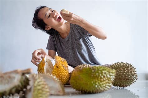 Premium Photo | Woman enjoy eating durian fruit