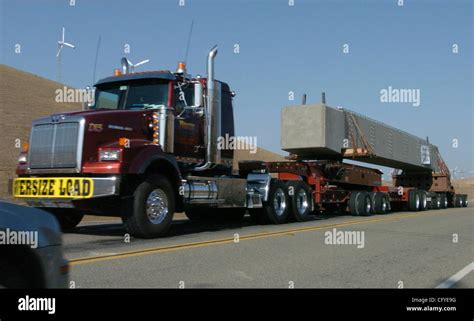 An eleven axle truck carries a 100 ton beam along Altamont Pass Road en ...