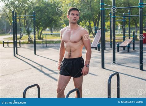 Fitnes Man Posing on Street Fitness Station Showing His Muscular Body ...