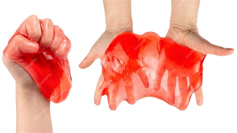 Premium Photo | Red slime toy in woman hand isolated on white top view