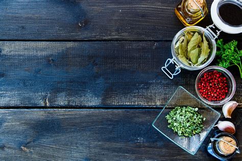 Cooking ingredients background - Rural table with cooking ingredients (fresh herbs, garlic ...