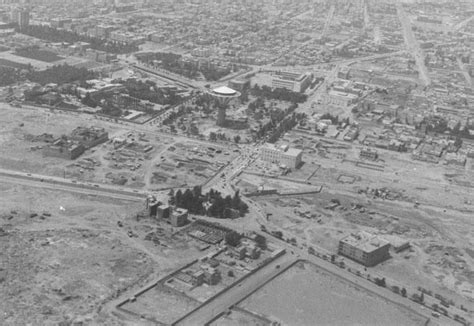 an aerial view of a large city with lots of buildings and trees in the ...