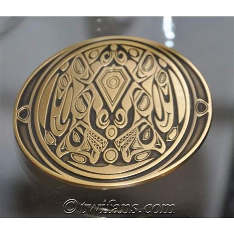 an intricately designed brass belt buckle on a black surface with gold trimmings