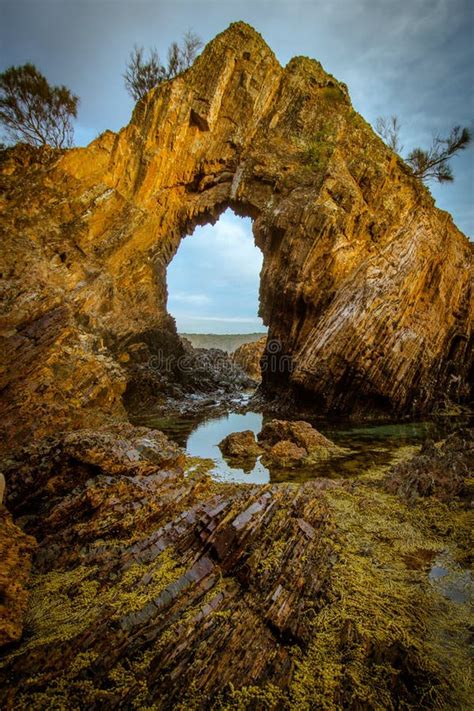 A Natural Arch on the Coast at Golden Hour Stock Image - Image of ...