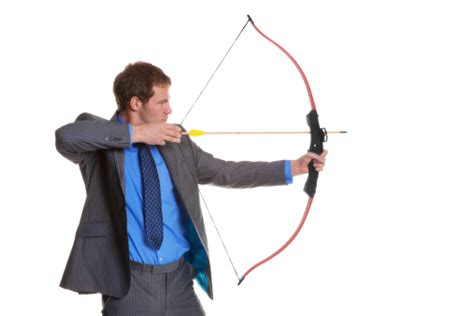 Businessman Shooting A Bow And Arrow Stock Photo - Download Image Now ...