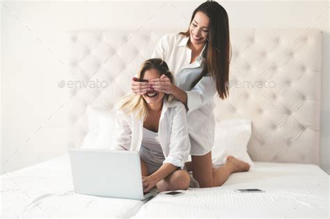 Two beautiful young girls having fun on bed Stock Photo by nd3000 | PhotoDune