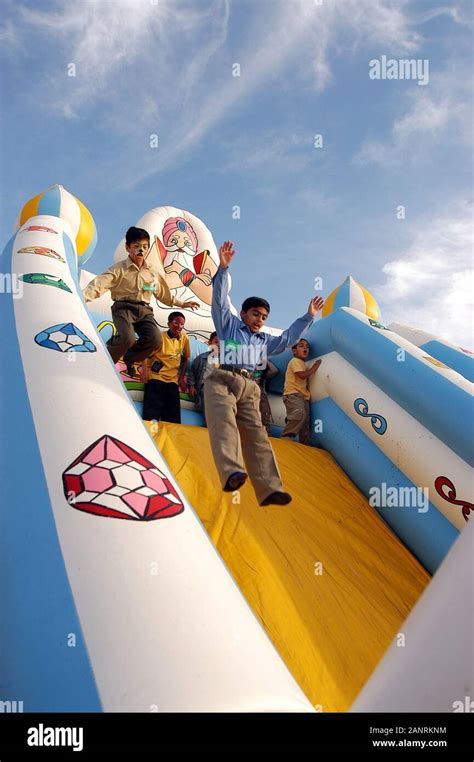 Kids playing, inflatable game Stock Photo - Alamy