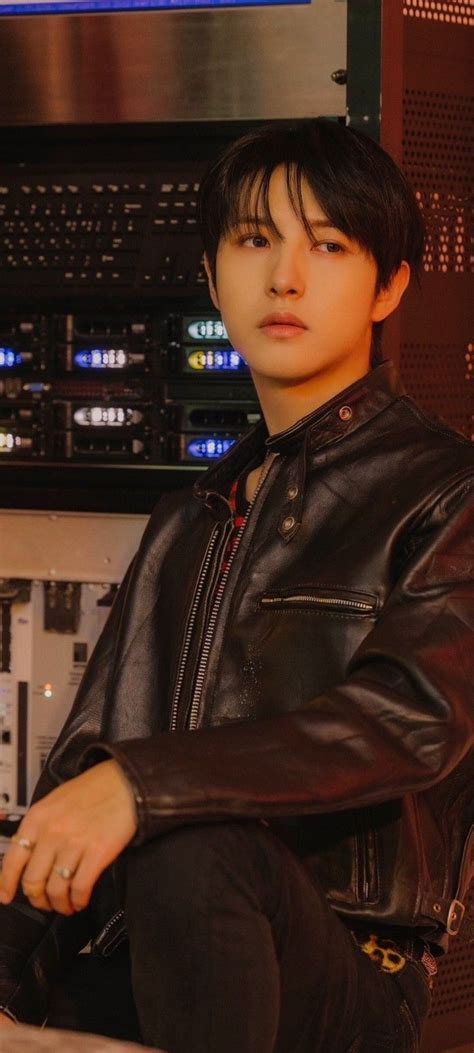 a young man sitting on top of a stool in front of a sound mixing equipment