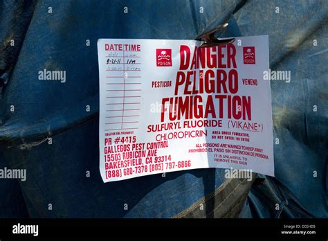 A warning sign on a tented house during fumigation process Stock Photo - Alamy