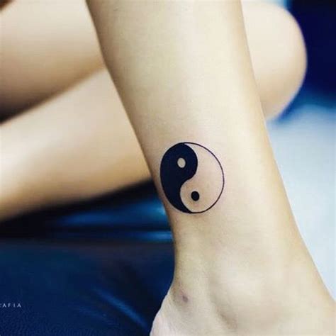 yin yang tattoo on foot | Yin yang tattoo design, Wrist tattoos for ...