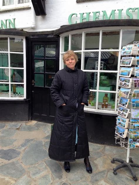 Selina Cadell stays warm between takes in front of her Chemist shop ...