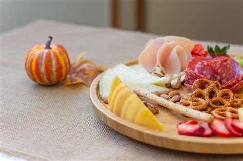 Premium Photo | Cold cuts and cheese platter on a table