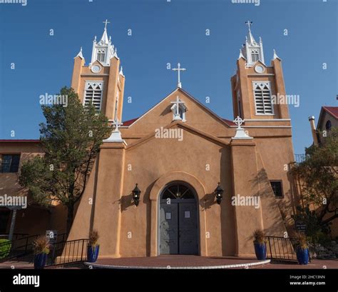 Exterior of adobe colored San Felipe de Neri Roman Catholic church in Old Town Albuquerque, New ...