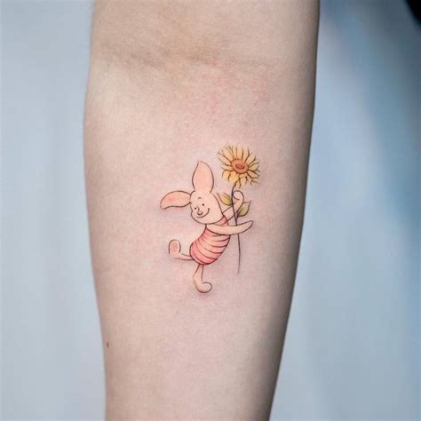 Piglet tattoo on the inner forearm