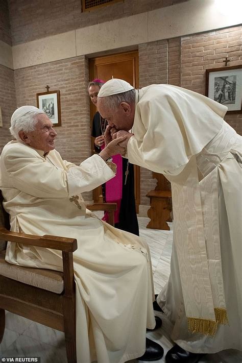 Pope Francis kisses the hand of Benedict XVI as he visits the 93-year-old after a ceremony to ...