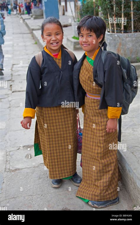 Students wearing traditional dress uniform in street in Thimphu Bhutan ...