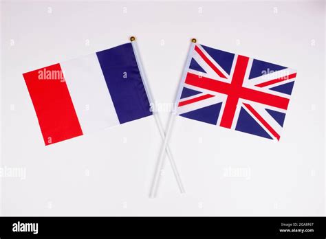 Flag of France and flag of Great Britain crossed with each other on a ...