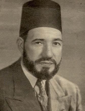 a black and white photo of a man in a suit with a hat on his head