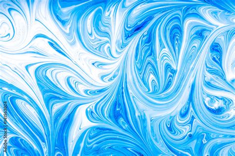 Blue and white paint mixing making swirls background. Stock Photo | Adobe Stock