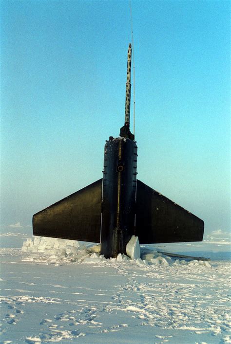 A US Navy submarine surfacing through arctic ice. Imagining the size of ...