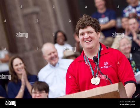 Male teenage Special Olympian speaks at podium outside the Texas Capitol building before the ...