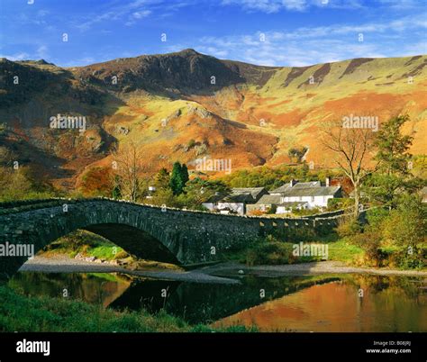 Grange in autumn, Lake District National Park, Cumbria, UK. Bridge over River Derwent Stock ...