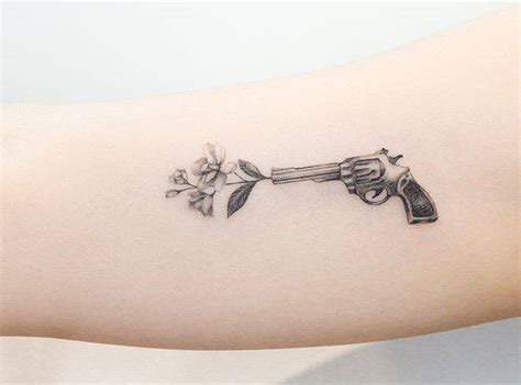 Flower gun tattoo detail.