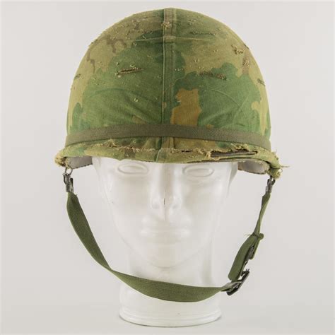 Lot - VIETNAM WAR M1 HELMET WITH CAMOFLAUGE COVER