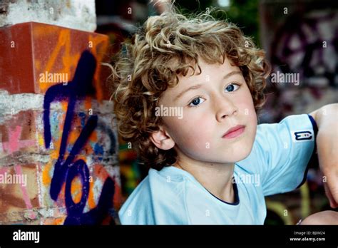 portrait of pensive young boy with curly hair Stock Photo - Alamy