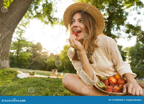 Pretty Young Girl in Summer Hat Having a Picnic at the Park, Sitting on a Grass Stock Photo ...