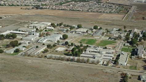 7.6K stock footage aerial video passing by the California Institution for Men prison in Chino ...