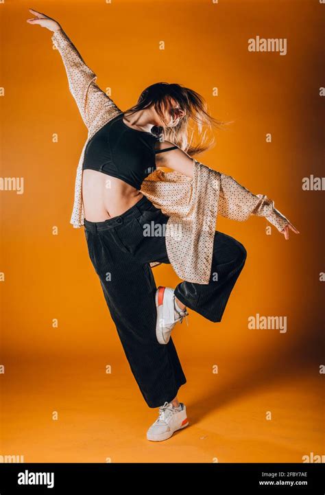 Flexible young dancer performing a stylish dance movement Stock Photo - Alamy