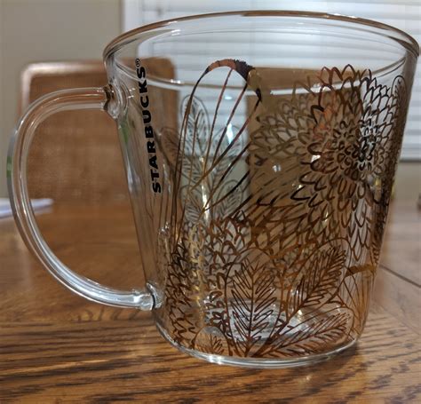 Brand new with tag Starbucks glass mug. It's.clear with gold designs. One of my favorite mugs ...